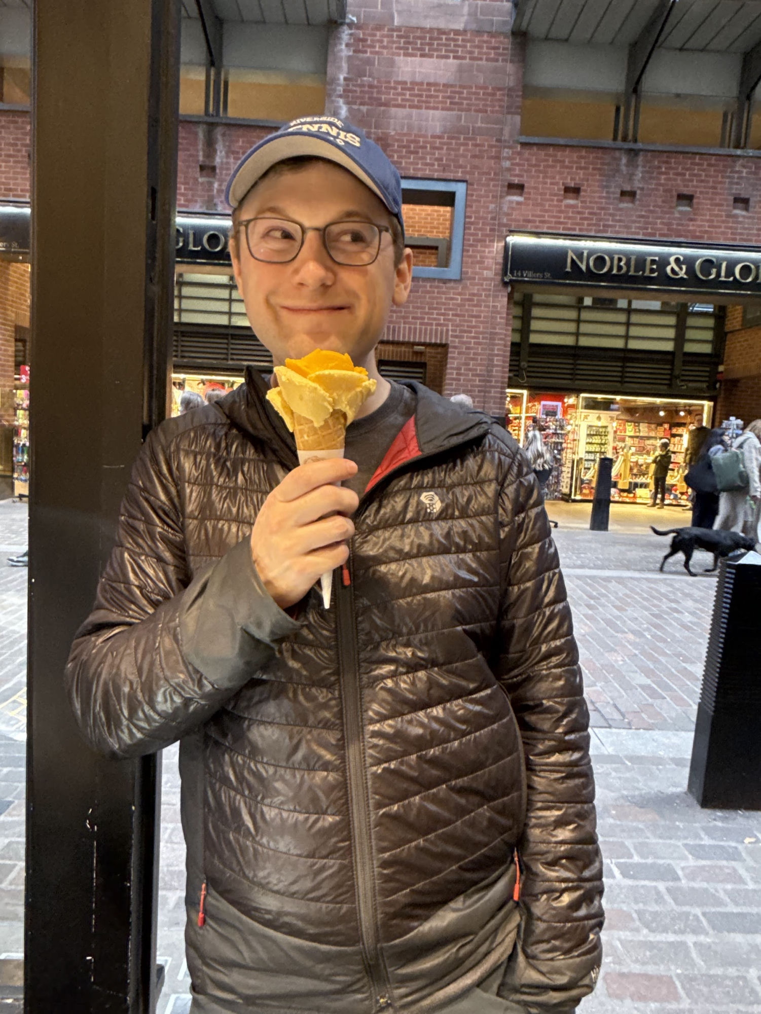 Grinning with a scoop of mango ice cream in a waffle cone